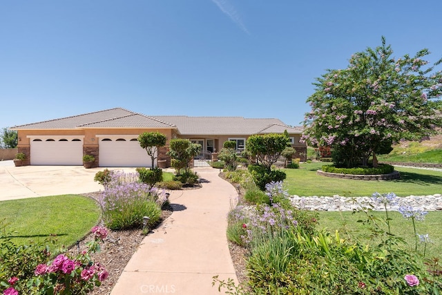 view of front of home with a front yard and a garage