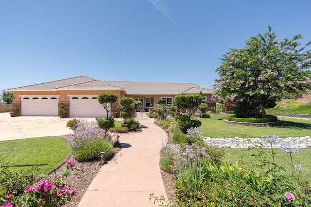 view of front of home featuring a tile roof, stucco siding, an attached garage, driveway, and a front lawn