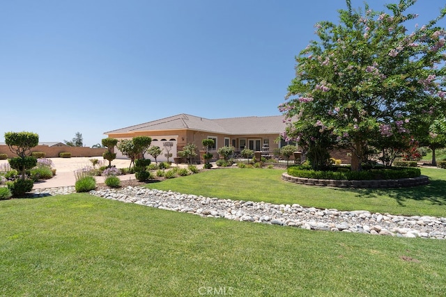 view of front of property with a front yard and a garage