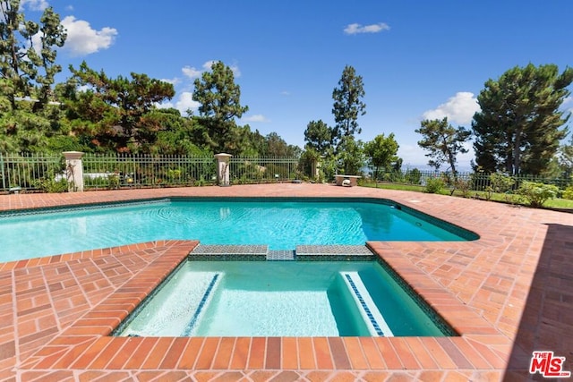 view of swimming pool with a patio