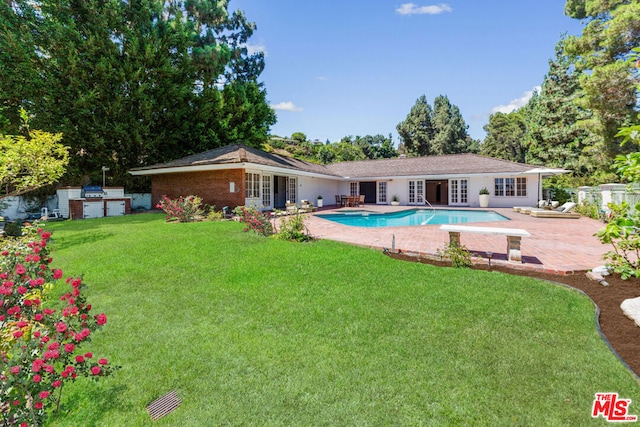 view of pool featuring an outdoor structure, a yard, and a patio