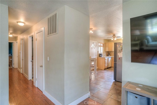 hallway featuring a textured ceiling