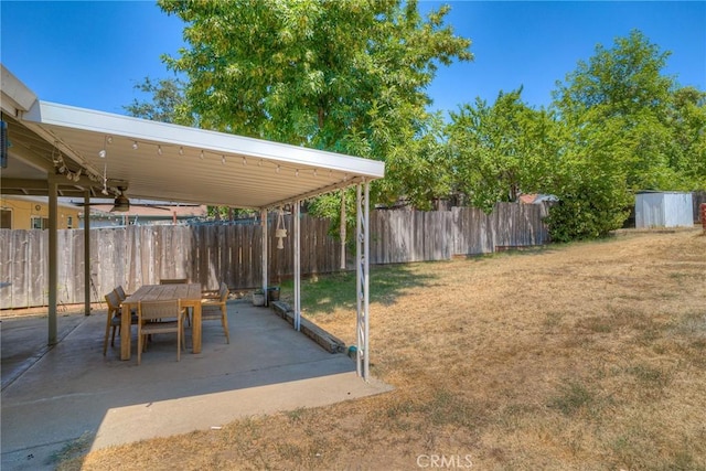 view of yard with a patio area and ceiling fan
