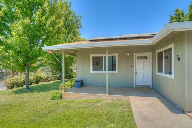 doorway to property featuring a lawn