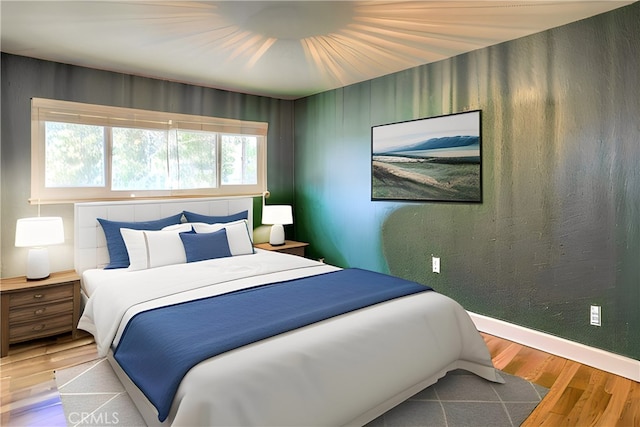 bedroom with wood-type flooring