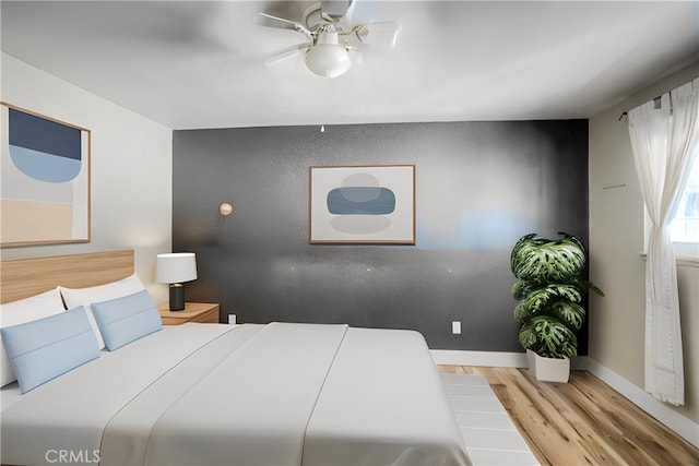 bedroom featuring ceiling fan and wood-type flooring
