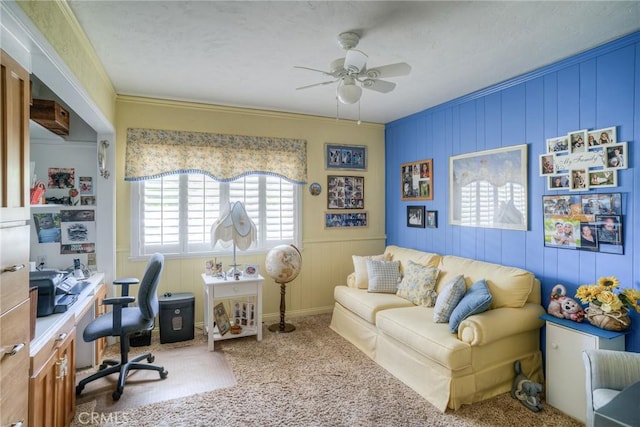 carpeted home office with crown molding and ceiling fan