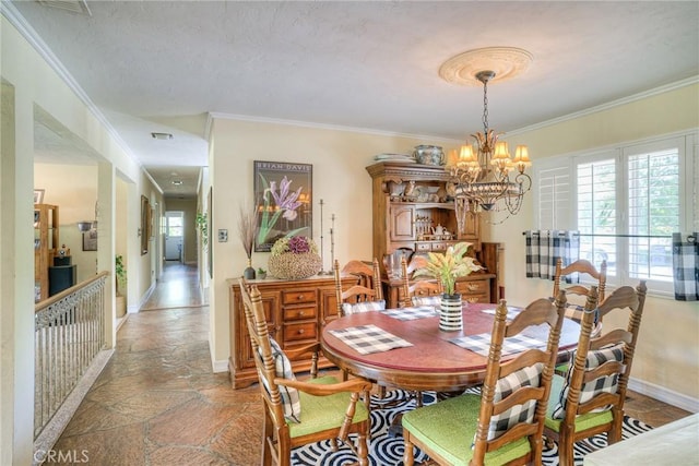 dining area featuring ornamental molding and a chandelier