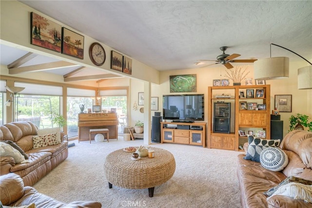 living room with a textured ceiling, beamed ceiling, ceiling fan, and carpet