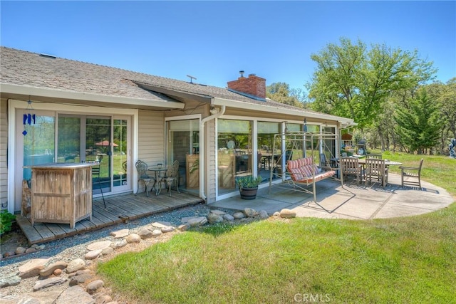 rear view of house with a patio area, a deck, and a lawn