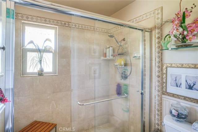 bathroom with an enclosed shower and toilet