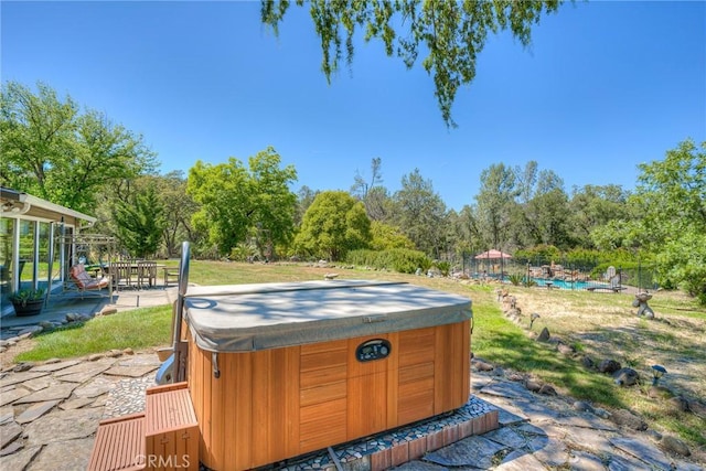 view of yard with a hot tub and a patio