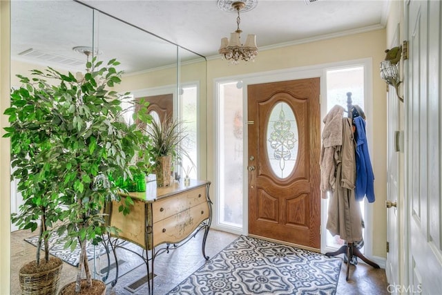 entrance foyer featuring an inviting chandelier and crown molding