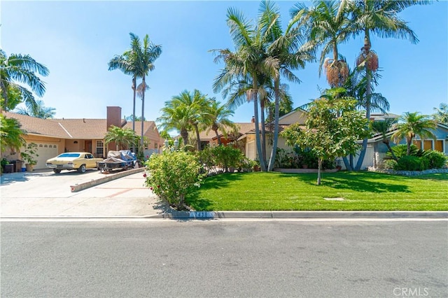 view of front of home with a front yard and a garage