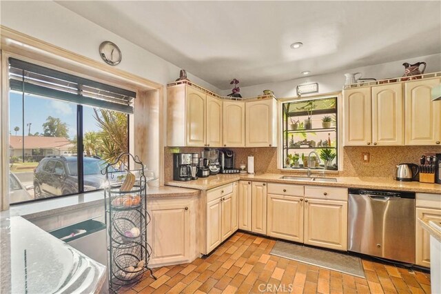 kitchen with backsplash, stainless steel dishwasher, and sink