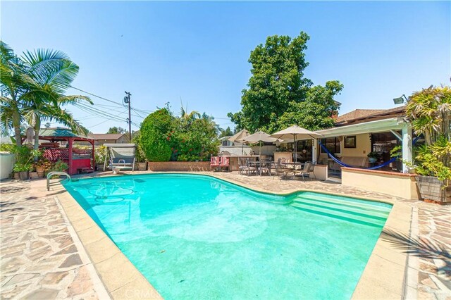 view of swimming pool featuring a gazebo and a patio