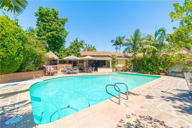 view of swimming pool with a patio area