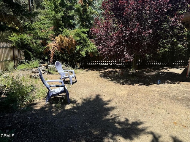 view of home's community featuring fence