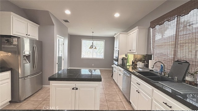 kitchen featuring sink, hanging light fixtures, a kitchen island, white cabinetry, and stainless steel appliances