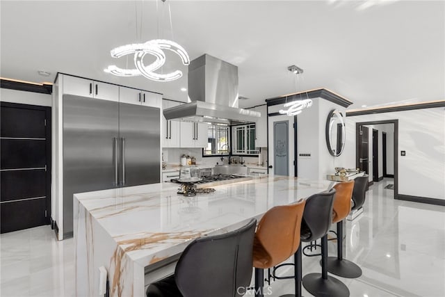 kitchen with pendant lighting, white cabinetry, a center island, and high end refrigerator