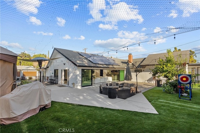 back of property featuring a patio, a yard, and an outdoor hangout area