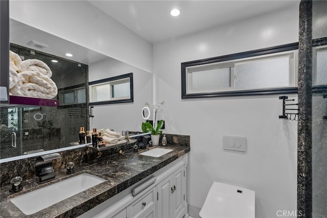 bathroom with vanity and a shower with door