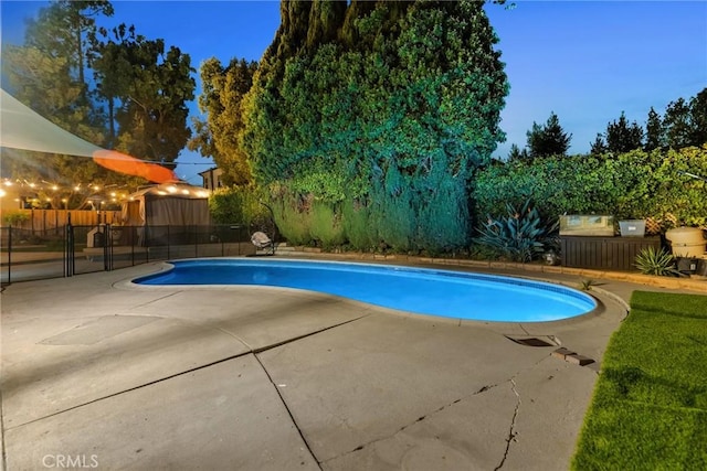 view of swimming pool featuring fence, a fenced in pool, and a patio