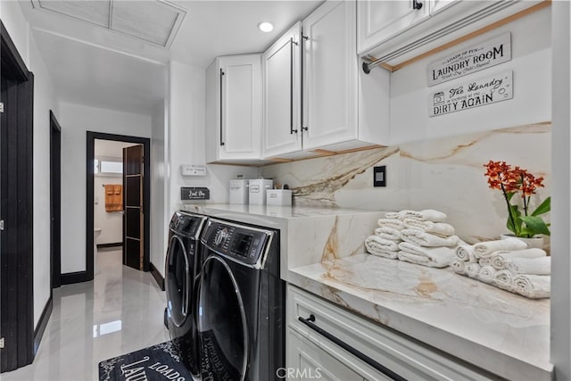 washroom featuring separate washer and dryer and cabinets