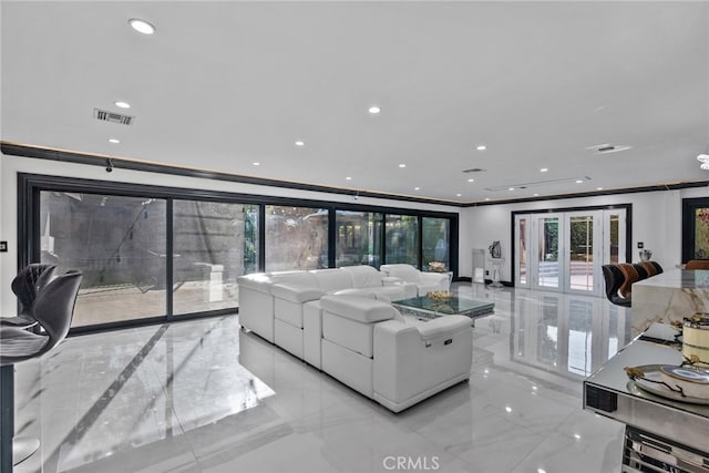 living room featuring french doors and ornamental molding