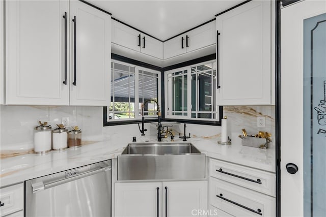 kitchen with dishwasher, light stone counters, sink, white cabinets, and backsplash