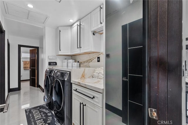 clothes washing area featuring attic access, washing machine and clothes dryer, cabinet space, baseboards, and recessed lighting