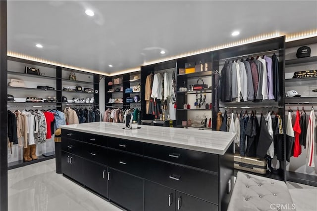 walk in closet with marble finish floor