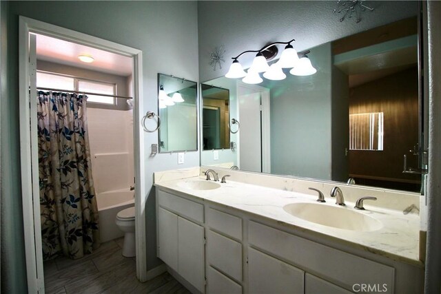 full bathroom featuring shower / bath combination with curtain, vanity, and toilet