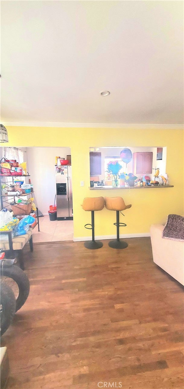 game room featuring wood-type flooring and crown molding