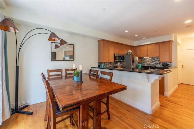 637 S Grand Ave Unit 4, San Pedro, CA 90731 - kitchen with appliances with stainless steel finishes, light wood finished floors, decorative backsplash, a peninsula, and recessed lighting