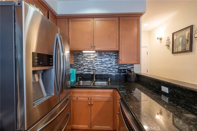 637 S Grand Ave Unit 4, San Pedro, CA 90731 - kitchen with stainless steel appliances, tasteful backsplash, brown cabinetry, and dark stone countertops