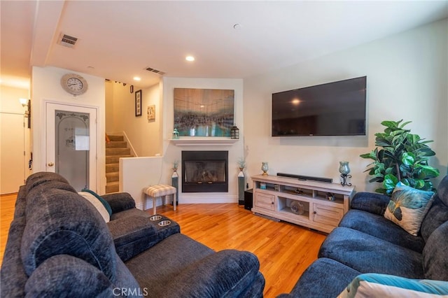 637 S Grand Ave Unit 4, San Pedro, CA 90731 - living room with light wood-style flooring, stairs, a glass covered fireplace, and recessed lighting