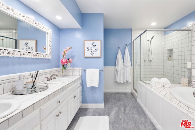 bathroom with a shower with shower door and vanity