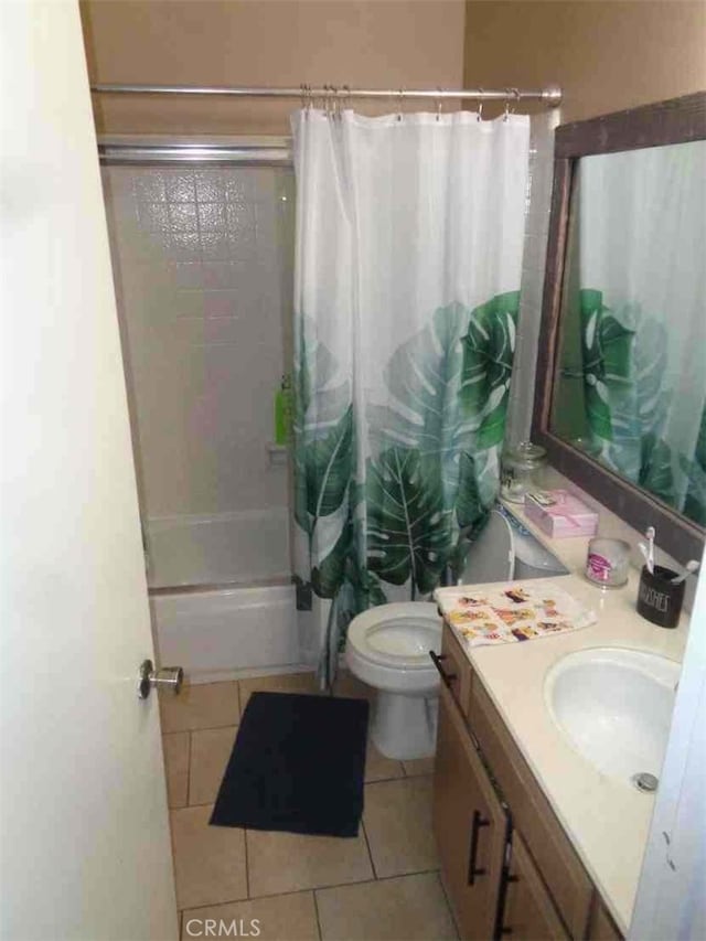 full bathroom with tile patterned floors, vanity, toilet, and shower / bathtub combination with curtain