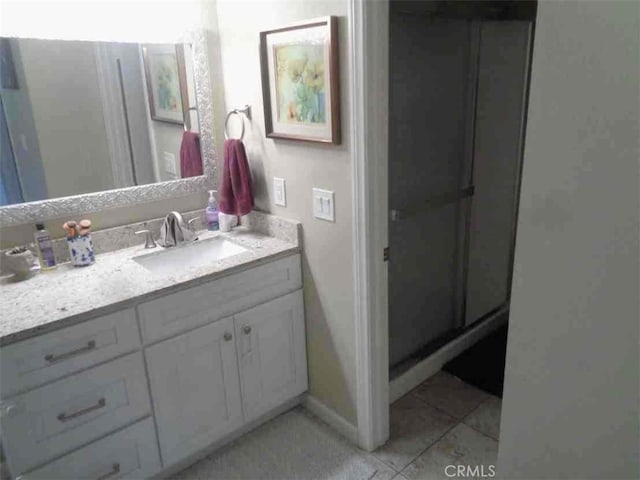 bathroom with tile patterned flooring and vanity