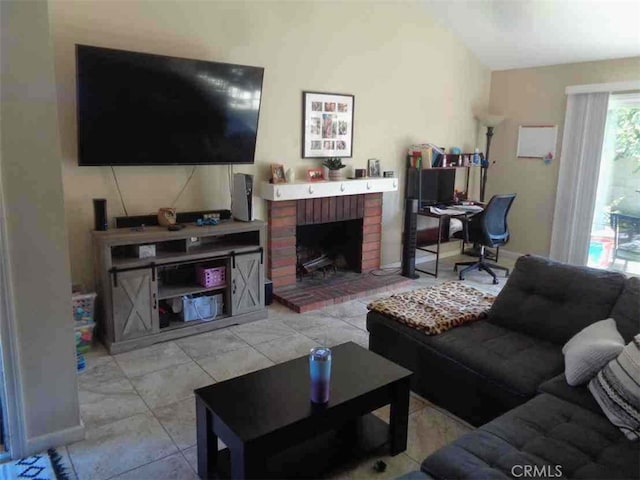 living room with a fireplace and light tile patterned flooring