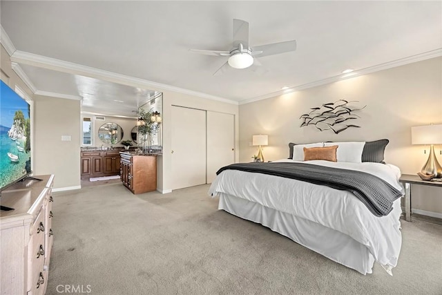 bedroom featuring ornamental molding, light colored carpet, a closet, and ceiling fan