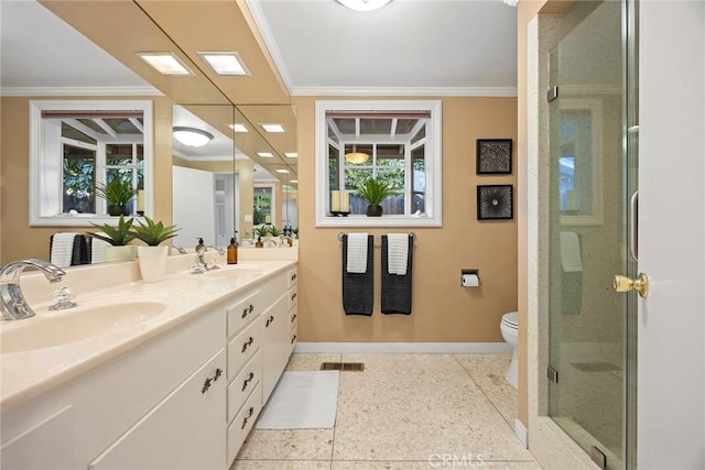 bathroom with vanity, crown molding, a shower with door, and toilet