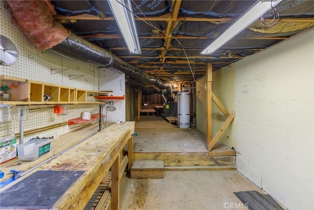 basement with a workshop area and strapped water heater