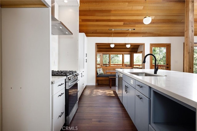 kitchen featuring sink, dark wood-type flooring, stainless steel appliances, decorative light fixtures, and wood ceiling