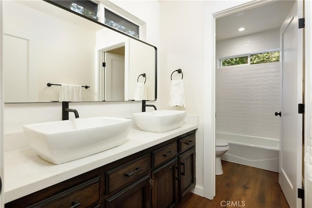 bathroom featuring hardwood / wood-style flooring, vanity, and toilet