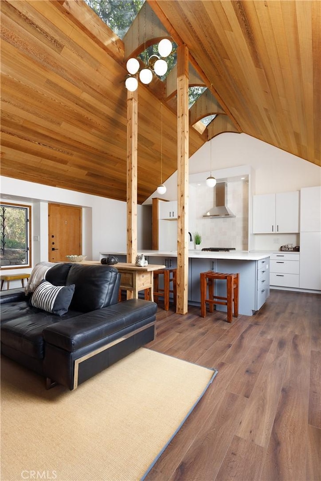 living room with hardwood / wood-style floors, high vaulted ceiling, and wooden ceiling