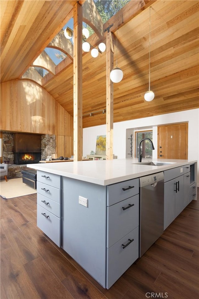 kitchen featuring lofted ceiling with skylight, sink, pendant lighting, wooden ceiling, and dishwasher