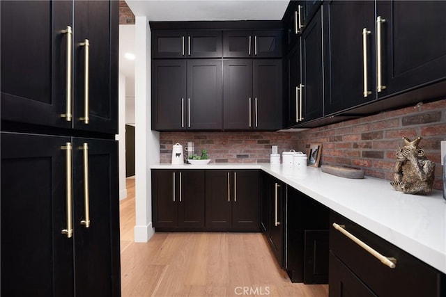 kitchen featuring backsplash, light hardwood / wood-style flooring, and high quality fridge