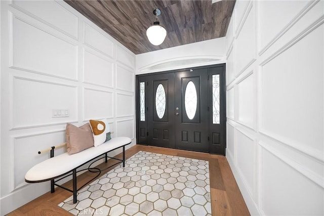 foyer featuring wood ceiling and light hardwood / wood-style flooring